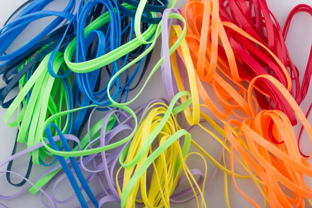 pile of colorful rubber bands on white background. - flexibility rubber rubber band tangled imagens e fotografias de stock