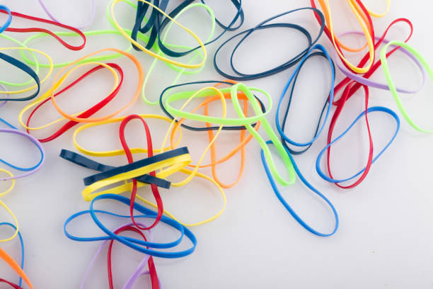 pile of colorful rubber bands on white background. - flexibility rubber rubber band tangled imagens e fotografias de stock