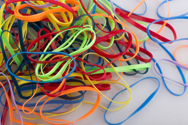 pile of colorful rubber bands on white background. - flexibility rubber rubber band tangled imagens e fotografias de stock