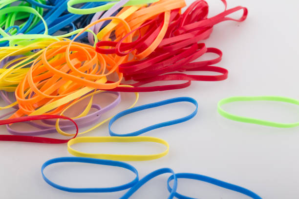 pile of colorful rubber bands on white background. - flexibility rubber rubber band tangled imagens e fotografias de stock