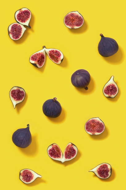 istock Colorful fresh figs fruit pattern on bright yellow background, whole and sliced fig. 1291330860