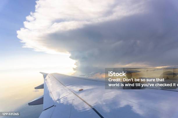 Sky Scape View From Clear Glass Window Seat To The Aircraft Wing Of The Plane Traveling On The Clouds And Sunshine With Blue Sky Stock Photo - Download Image Now