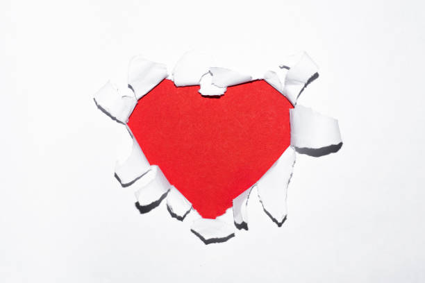 istock Happy Valentines Day background. Heart shaped red hole in paper. Empty space for text. 1291334170