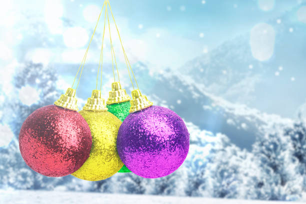 istock Colorful Christmas ball hanging with snowfall background 1291340034