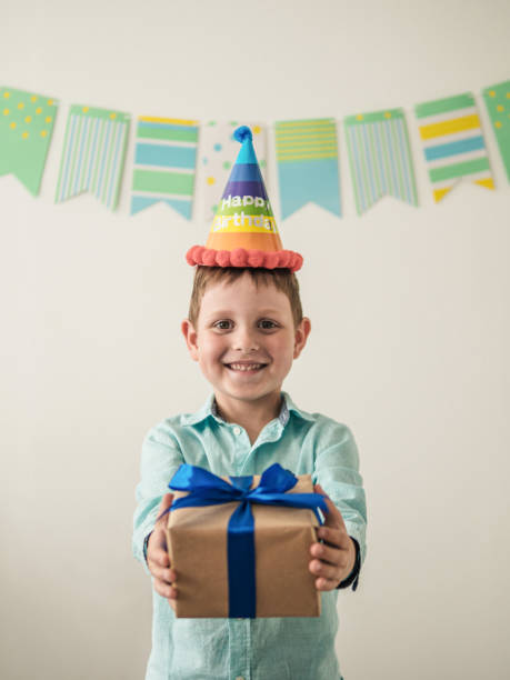 istock Five year old boy in his birthday hold gift box 1291340865