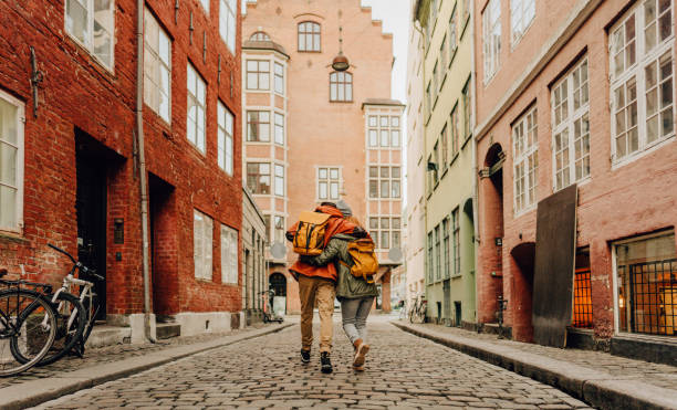 City love Photo of a happy young couple, sharing their love and affection while walking down the street, on a cold winter day. winter city stock pictures, royalty-free photos & images