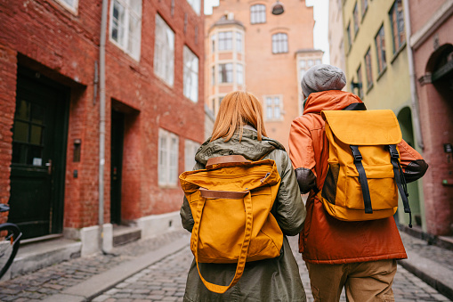 Photo of a young couple exploring streets and wandering around the city; taking a trip after a long time, appreciating the view, and getting to know the new city.