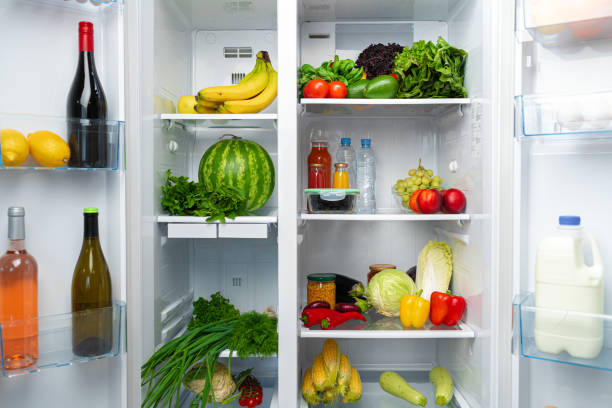 istock Open fridge full of fruits, vegetables and drinks 1291345401