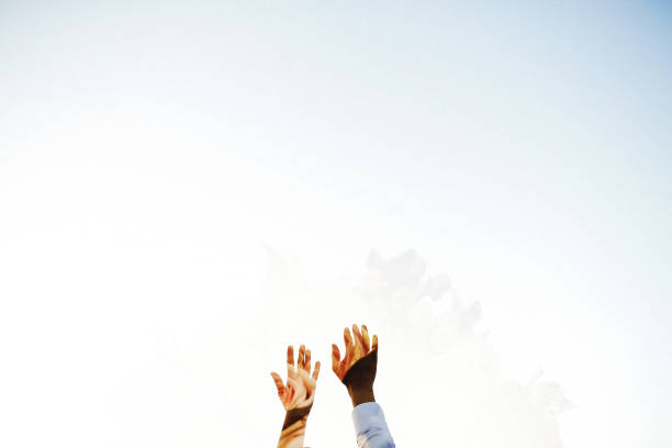 istock Wedding couple hands on the sky background 1291345693
