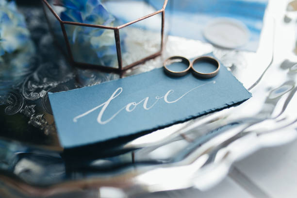 istock Wedding rings at wedding invitation with decorations 1291345841