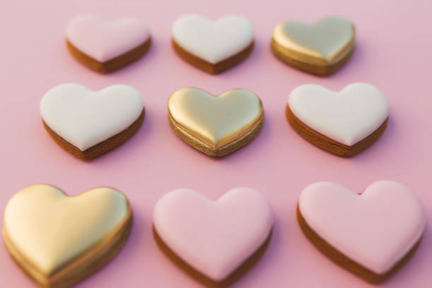 istock Pink background with sweet gingerbread heart cookies 1291345883