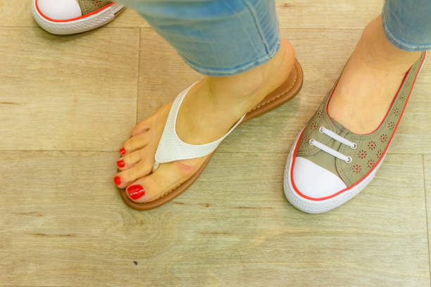 istock Unrecognizable woman trying on flip flops 1291346592
