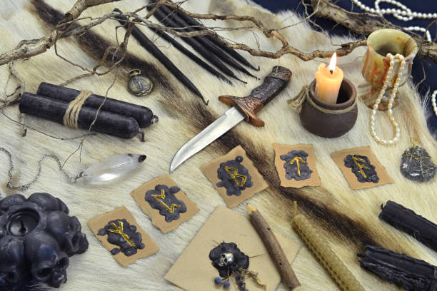 istock Still life with runes, ritual knife and black candles on witch table. 1291347950
