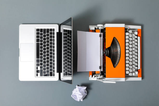 istock Digital and analog – Laptop and 70s Typewriter 1291349084