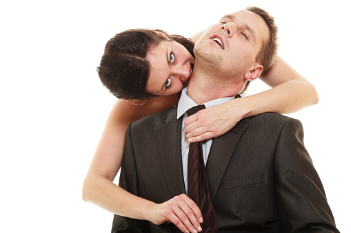 Emancipation. Woman pulling tie of man, wife showing her domination over husband isolated on white.