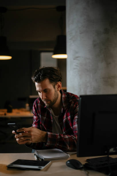 istock Young businessman using the phone in the office 1291349709