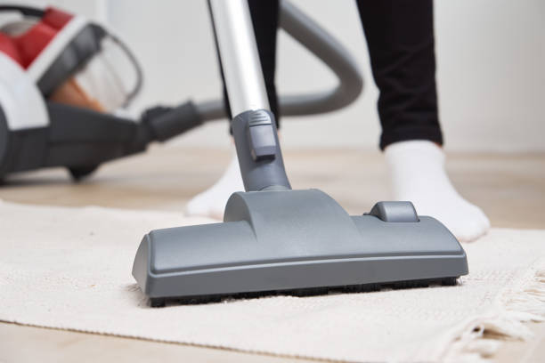 istock Woman use vacuum cleaner at the floor 1291350732