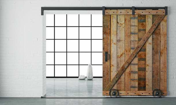 Barn Sliding Wooden Door in Loft Room 3d illustration. Modern interior in loft style barn sliding wooden door in loft room. Studio industrial style photos stock pictures, royalty-free photos & images