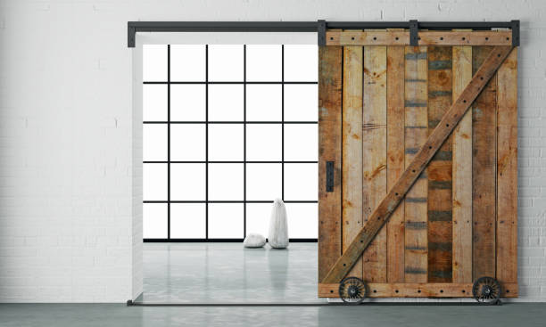 Barn Sliding Wooden Door in Loft Room 3d illustration. Modern interior in loft style barn sliding wooden door in loft room. Studio barn doors stock pictures, royalty-free photos & images