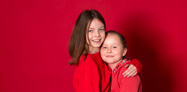 istock Best girlfriends in front of red background 1291353051