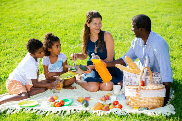istock Couple with children at picnic 1291353637