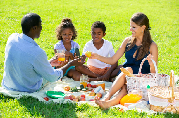 istock Parents with daughter and son at picnic 1291353678