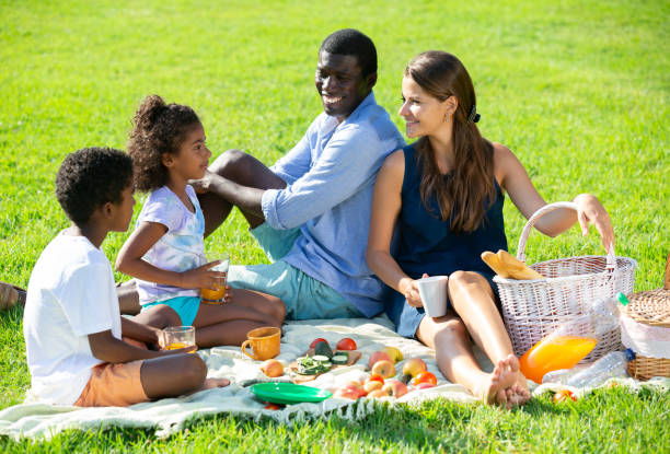 istock Couple with children at picnic 1291353682