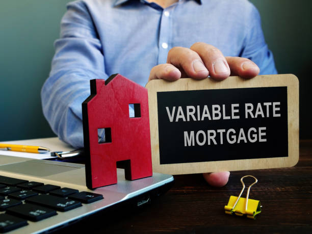 istock Real Estate Agent offers Variable rate mortgage and holds plate. 1291354368