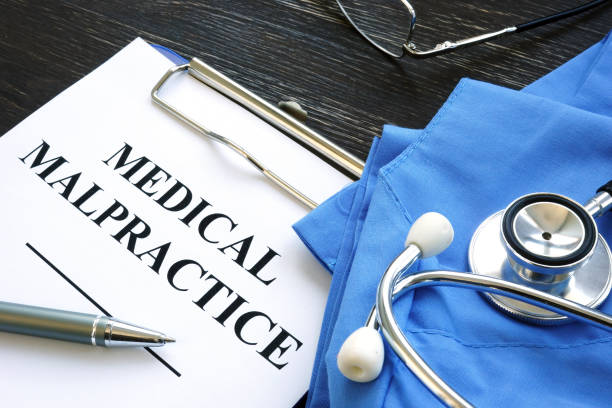 istock Medical malpractice. Medical suit, stethoscope and papers. 1291354679