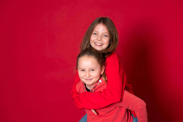 istock Best girlfriends in front of red background 1291354754