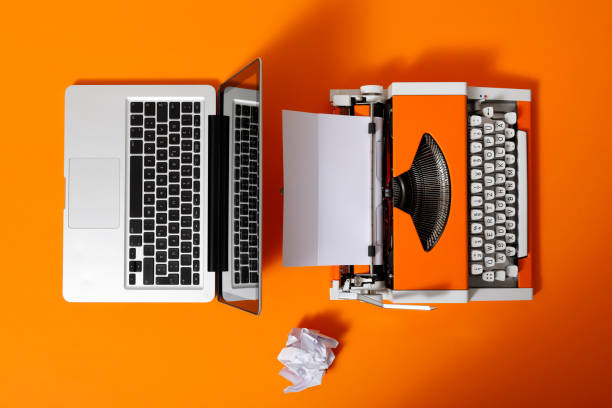 istock Digital and analog – Laptop and 70s Typewriter 1291354830