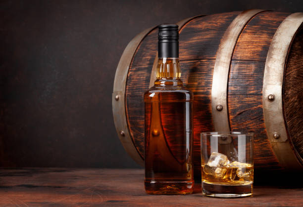 istock Scotch whiskey bottle, glass and old barrel 1291354934