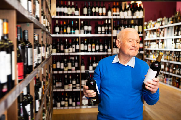istock Positive man chooses red wine 1291355194
