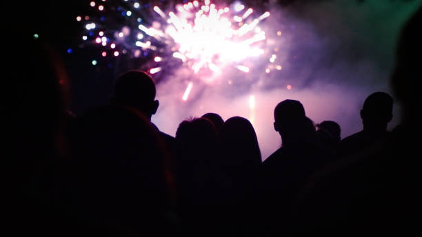 istock Crowd watching fireworks and celebrating new year eve 1291355266