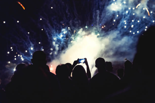 istock Crowd watching fireworks and celebrating new year eve 1291355285