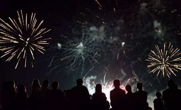 istock Crowd watching fireworks and celebrating new year eve 1291355324