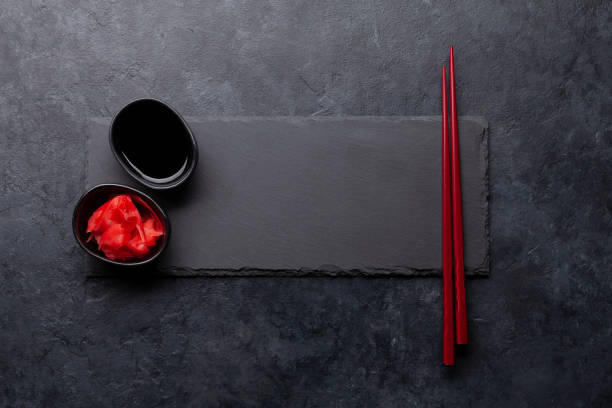 istock Stone plate and chopsticks for your sushi and maki 1291355440