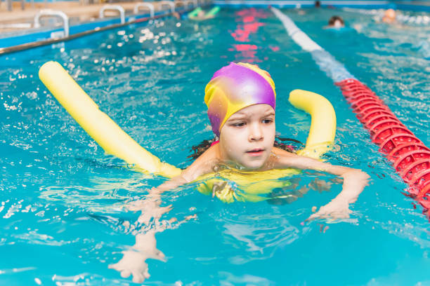 istock Small child swim in an indoor pool. 1291355998