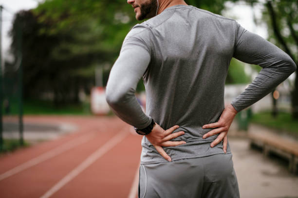istock Sportsman feeling backache at a park 1291356130