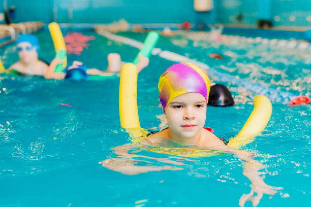 istock Small child swim in an indoor pool. 1291356162