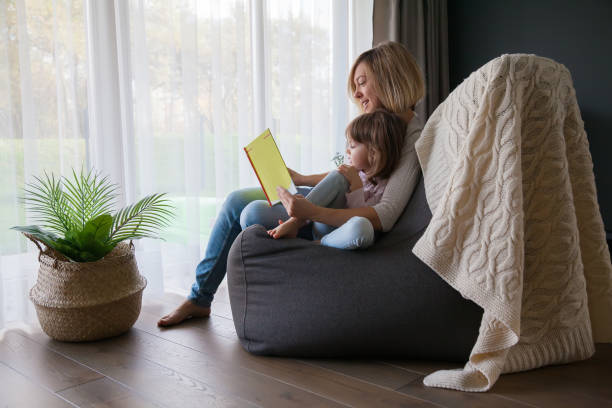 istock Mother reading a book to her little daughter 1291357974