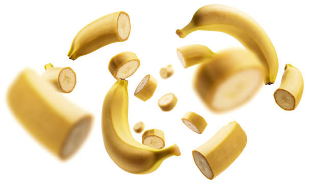 The levitated pieces of bananas on a white background stock photo