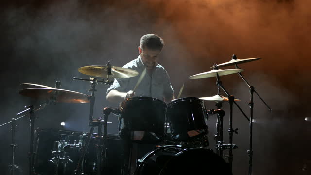 The drummer is rehearsing drums before a rock concert. Man records music on drums