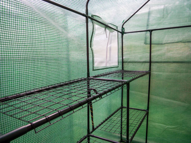 the interior of a small greenhouse for seedlings - construction frame plastic agriculture greenhouse imagens e fotografias de stock