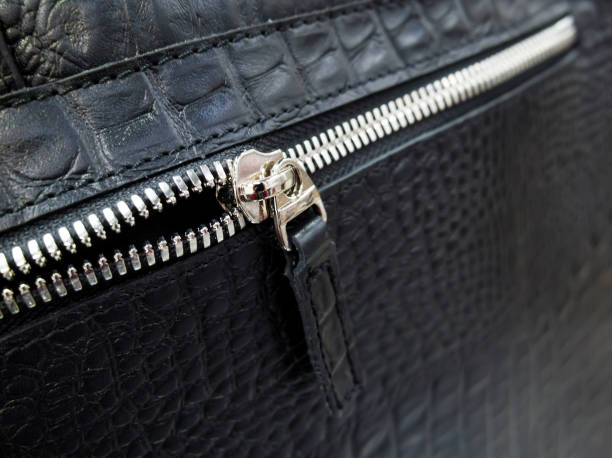 istock Silver-tone zip fastener on a black leather bag 1291358989