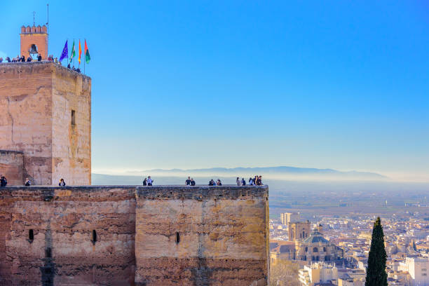 Spectacular view of Alcazaba medieval fortress from Sabika Hills in Granada. Sight of the ramparts and towers in the Arab, Moorish style. Amazing skies above. Alhambra de Granad, Andalusia, Spain.