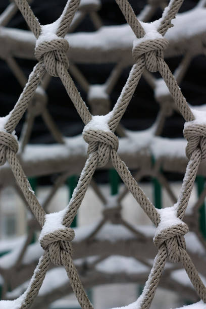 istock snow on the rope structure on the playground 1291360639