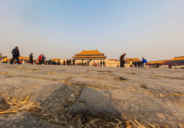 Beijing, China - November 19, 2019: The forbidden city in Beijing. A shot from the ground with the cobblestones in the foreground and the Zhaoxian Temple in the background