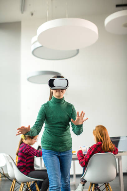 istock Kids having fun with VR glasses 1291361804