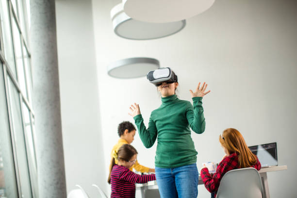 istock Kids having fun with VR glasses 1291361880